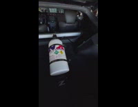 Black car in garage turns on revs engine exhaust pop