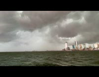 Collab WINY - Thunderstorm clouds approach Manhattan long boat in the background
