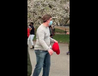 Guy roller skates with bird in bag