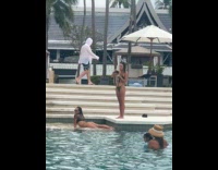 Woman bikini lie down pose at pool