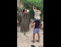 Two men ride shoulder woman high chair