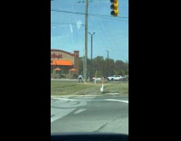Man jacket hoodie dances beside street post