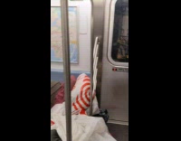 Pile of trash bags in corner of subway train