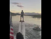 Blue shirt guy water hoverboard catches beer 