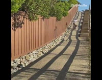 Guy rides skateboard down concrete hill fail 