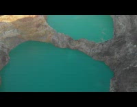 Drone flies over round blue water