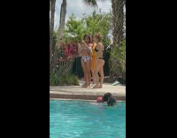 Lady in black bikini jumps and checks how photo turned out 