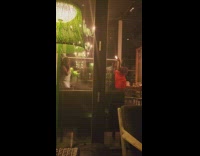 Woman glitter dress pose in bar green lamp