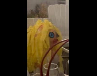 Weird looking blow up doll  on chair