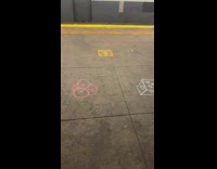 Guy draws faces on subway ground
