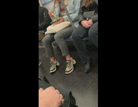 Girl eats sushi on one end of subway train, guy in ski burglar mask on other side