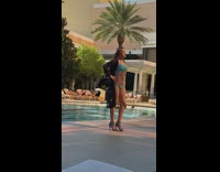 Woman blue bikini black dress costume poolside