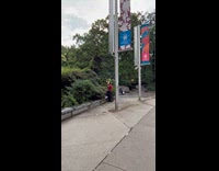 Guy praying at park sits at bin
