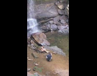 Girl black bikini sit rock small waterfalls