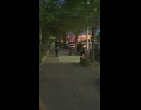 Officer hula hoops on sidewalk at night 