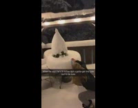 Girl measuring snow on table with blue ruler