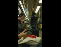 Guy quietly vogues and dances by himself on subway train