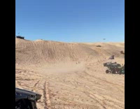 White desert car jumps into air and lands 