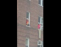 Red shirt guy plays saxophone apartment window 