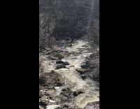 Person dances alone colorful ribbons river 