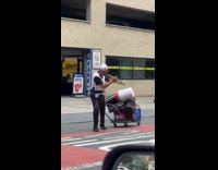 Collab WINY - Man play trumpet pull trolley with instrument cases