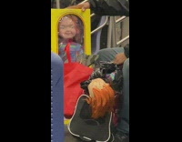 Guy riding subway with cabbage patch kids
