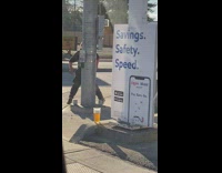 Guy practices kicking does handstand on sidewalk 