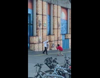 Guy poses by graffiti art wall
