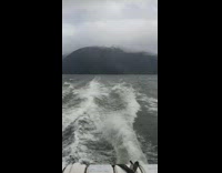 Person on boat film mountains reach clouds