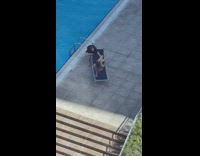 Woman in bikini poses and directed by her friend