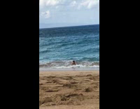 guy in blue shorts on skimboard in water 