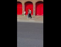 Woman Poses in front of Fire Station 