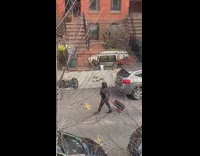 Guy walking down street talks into microphone 