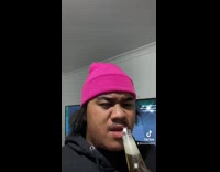 Collab BitchIG2 - Guy in pink beanie opens corona beer with mouth and then chugs it slowly