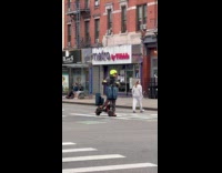 Guy rides scooter while playing opera music