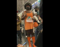 Woman dressed as orange jarritos drink