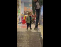 Baby goes up and down the moving walkway 