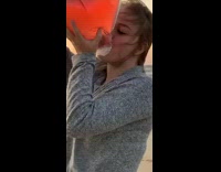 Girl on beach drinking couple background