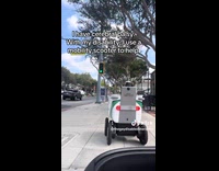 Delivery robot blocks mobility scooter on street