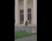 Couple maternity photo shoot in front of columns and stairs