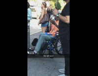 Guy orange shirt on blue wheelchair uses banana as a phone and talks to it 