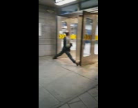 Guy spreads legs wide open and holds door open 