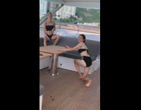 Black bikini girl poses grey seat boat