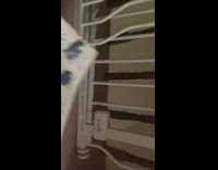 Guy peels dried paint off white paper 