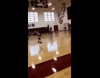 Girl gets hit in the face by ball during high school volleyball game in gym