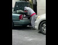 Guy Does Dumbbell Workout Next to Sidewalk 