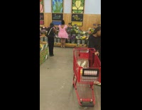 Woman pink ruffle dress arrange grocery flowers