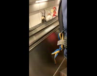 Angel pope and monster go down escalator 