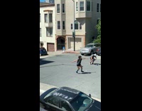 Grey shirt person spins across road incline