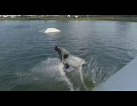 Red helmet guy wakeboards on obstacle course